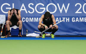 Dean Couzins (L) and Simon Child of New Zealand dejected after losing the bronze medal match.