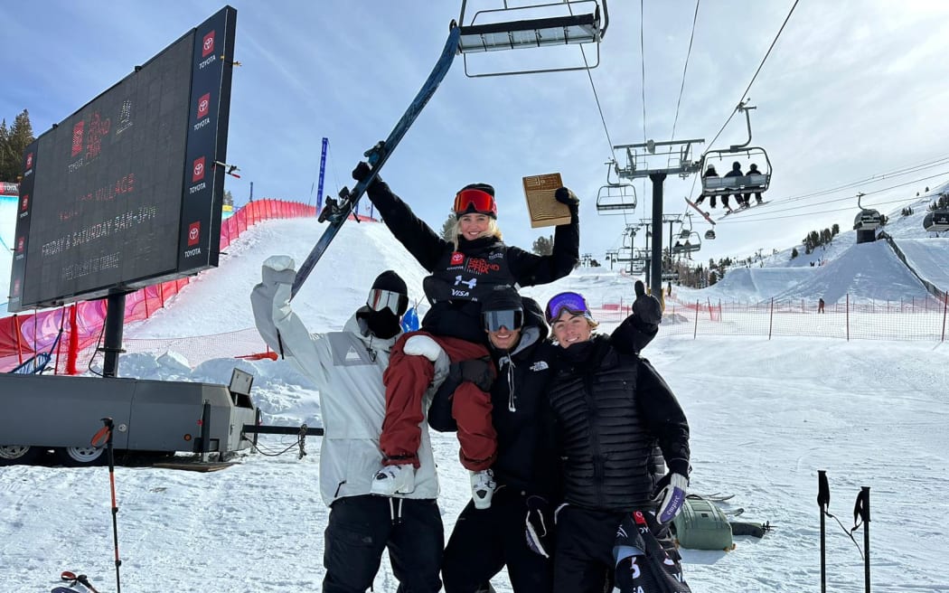 Ruby Andrews celebrates with her coach Hamish McDougall and teammates Ben Barclay and Luca Harrington.