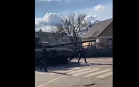 The video of a Ukrainian man kneeling in front of a Russian tank has been widely shared on social media.