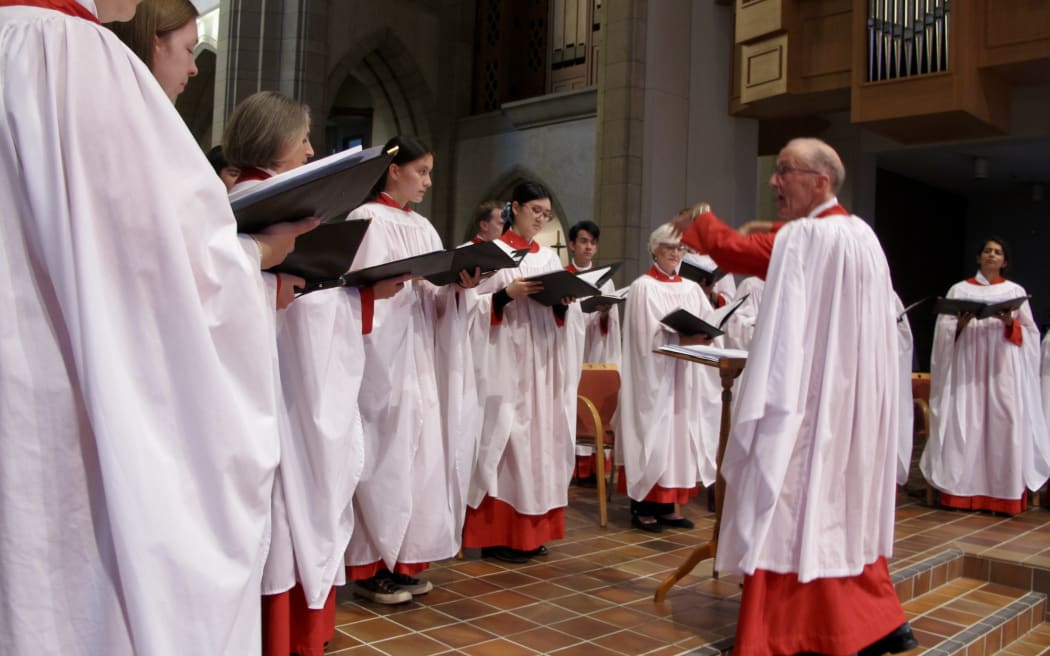 The choir director Peter Watts conducting the choir