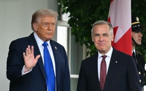 US President Donald Trump greets Canadian Prime Minister Mark Carney upon arrival at the West Wing entrance to the White House in Washington, DC on October 7, 2025. Carney's meeting comes as he hopes of convincing President Donald Trump to ease US tariffs that are negatively impacting Canada's economy. (Photo by Jim WATSON / AFP)