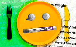 Plate, knife and fork with weight loss pills and syringe.