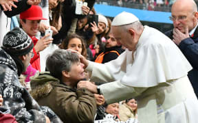 Pope Francis greets a handicapped wellwisher as he arrives at the Swedenbank Stadion in Malmo, Sweden, where he is to hold a mass on November 1, 2016.