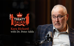 Crest referencing the nz coat of arms but featuring silhouette of a woman holding tino rangatiratanga flag and a crown with māori designs and the word Aotearoa at the base.
Colours are mainly red with some cream, all on a black background.
Text reads Kara Rickard with Dr. Peter Adds. 
Image of guest in conversation with host Kara (who is out of shot)