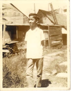 Alan aged about 10. His village is more crowded as more and more squatters also built on the land.