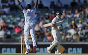 South African cricketer Kagiso Rabada celebrates the wicket of Steve Smith during their first Test against Australia