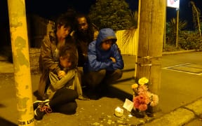 Malik Ricks (Dad), Suki Hickling (Mum) Frida Ricks (daughter) and Tahi Ricks who laid flowers and lit candles at cordon by Linwood mosque this evening - March 15 2019