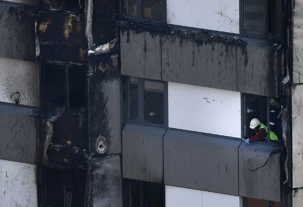 Untouched cladding on the burnt out upper floors of the Grenfell Tower block in a photo taken on 14 June 2017.