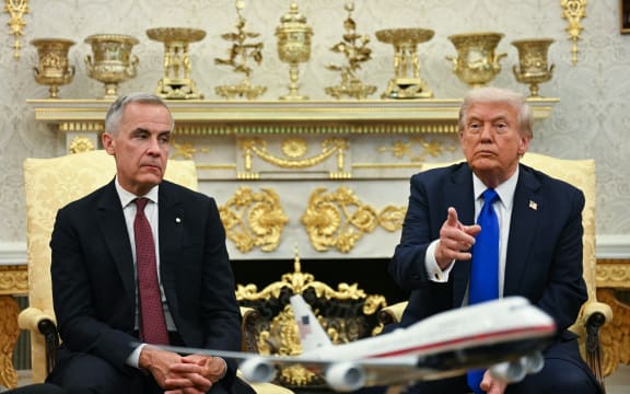 US President Donald Trump meets with Canadian Prime Minister Mark Carney in the Oval Office of the White House in Washington, DC, on 7 October, 2025.