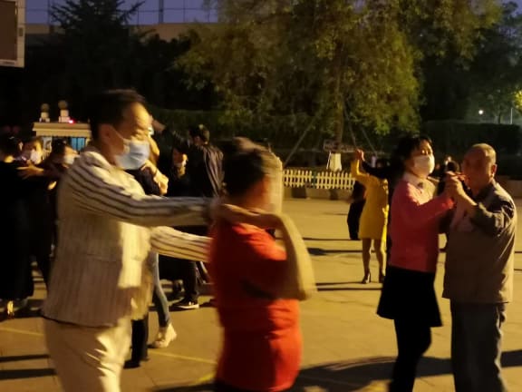 Dancers return to a public square in Chengdu