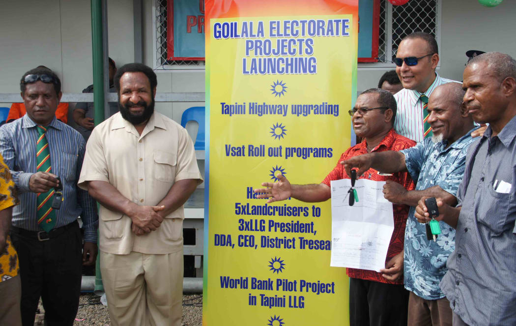 Goilala MP William Samb (red shirt) with Don Polye (cream suit) and Sam Basil (sunglasses) at the launch of a Goilala electorate Highway upgrade.