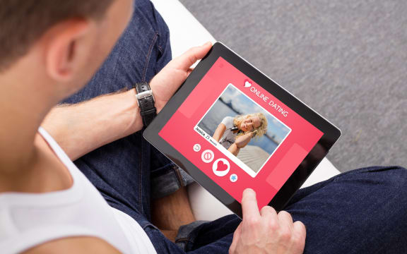 67741981 - man using online dating app on tablet