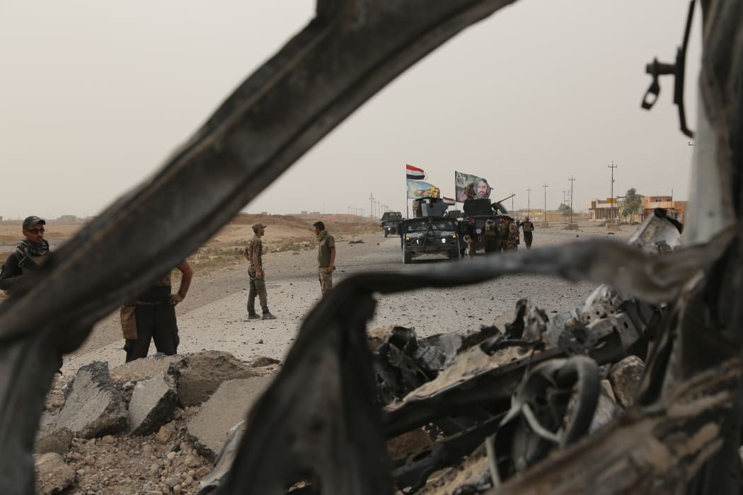 Iraqi troops on the Mosul-Erbil highway 
as part of the operation to drive IS militants from Mosul.