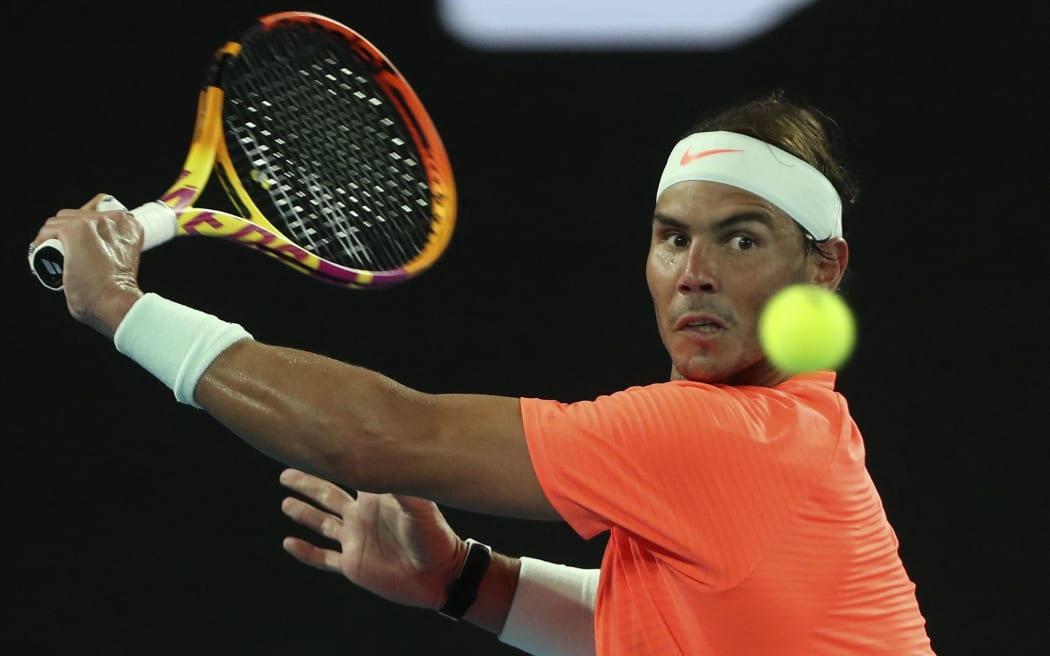 Spain's Rafael Nadal hits a return against Michael Mmoh of the US during their men's singles match on day four of the Australian Open tennis tournament in Melbourne on February 11, 2021.