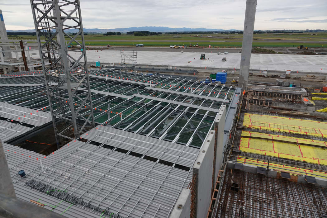 Roofs for the Ōhakea Air Force base aircraft hangars are being built on the ground. Cranes will hoist them into place.