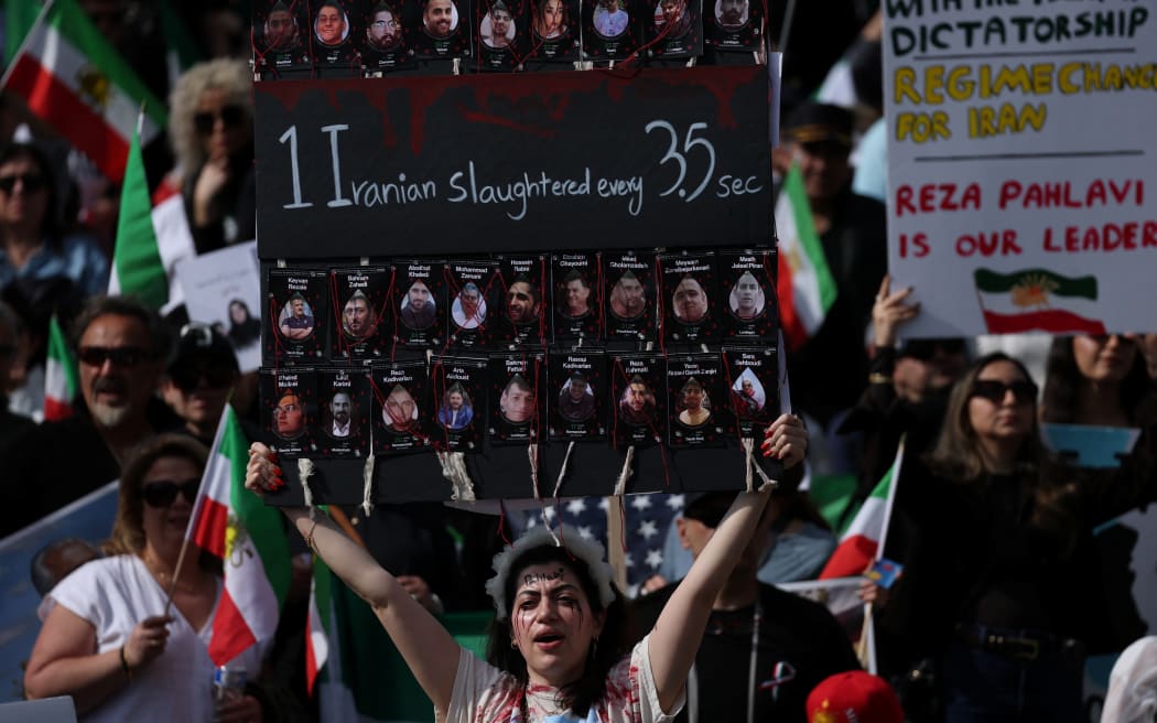Demonstrators rally in solidarity with the Iranian protest movement in Los Angeles on February 14, 2026. The exiled son of Iran's last shah said he was ready to lead the country to a "secular democratic future" at a rally in Munich on Saturday, after US President Donald Trump said a change of power would be the "best thing". (Photo by Patrick T. Fallon / AFP)