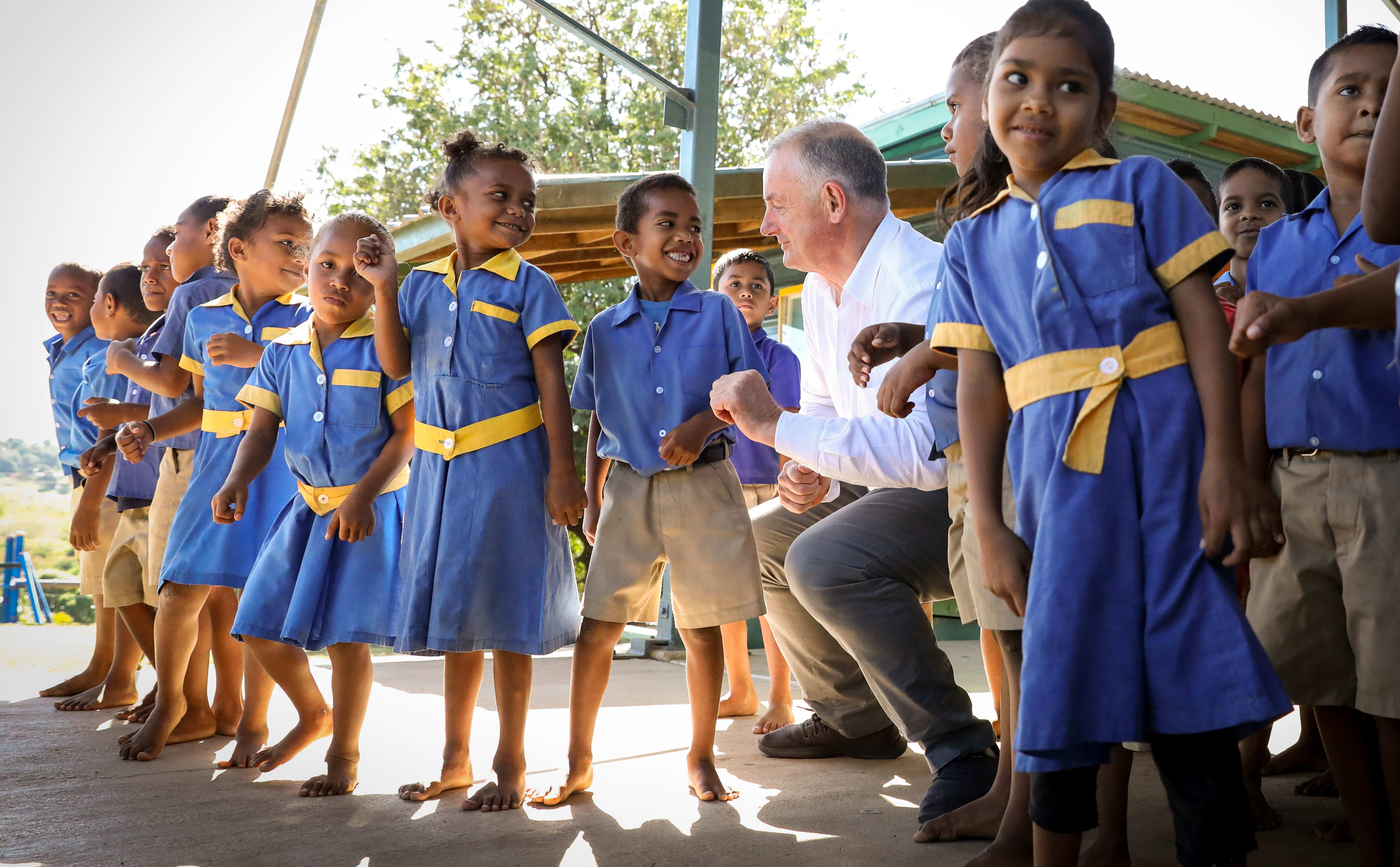 Speaker Trevor Mallard learns some new dance moves from the children at Koroipita Kindergarten in Fiji