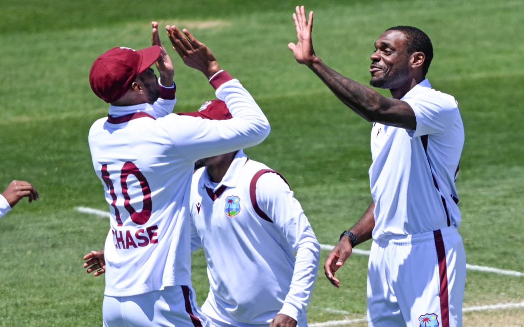 Justin Greaves of West Indies celebrates with Roston Chase (captain) of West Indies and team after his wicket of Devon Conway of New Zealand on Day 2 of the 2nd cricket test match between New Zealand and West Indies at the Basin Reserve in Wellington, New Zealand. Thursday 11 December 2025. © Photo: Andrew Cornaga / Photosport
