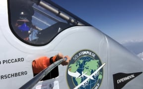 Bertrand Piccard takes a photo using a selfie stick during the flight from Chongqing to Nanjing.