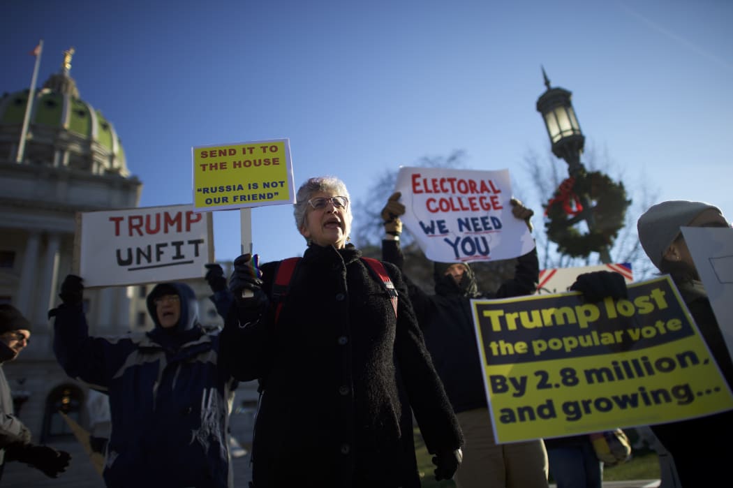 Protestors demonstrate outside the Pennsylvania Capitol Building before electors arrive to cast their votes.