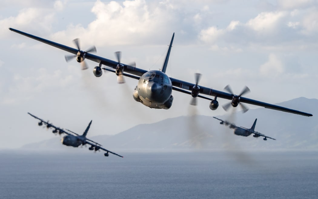 C-130H(NZ) Hercules aircraft from No.40 Squadron flying over the Auckland area with three MC-130J United States Air Force aircraft.