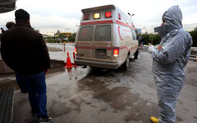 Medical staff receive patients as they arrive in ambulances at a hospital in Arbil, the capital of the Kurdish autonomous region in northern Iraq, on March 4, 2017, following a reported chemical attack.