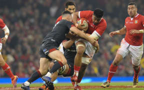 Tonga's Dan Faleafa is tackled by Tomos Williams during the 74-24 defeat in Cardiff.