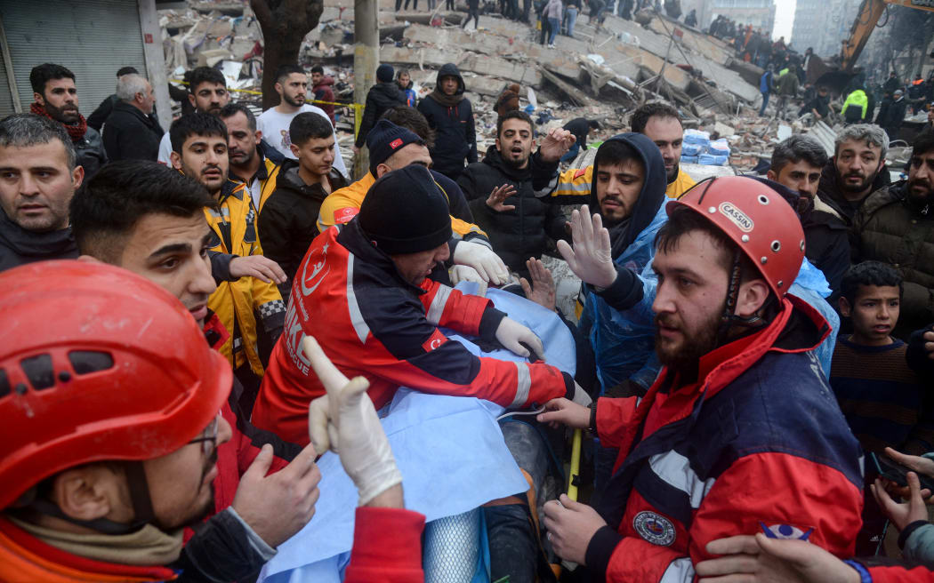 Rescue workers and volunteers pull out a survivor from the rubble in Diyarbakir on 6 February 2023, after a 7.8-magnitude earthquake struck the country's south-east.