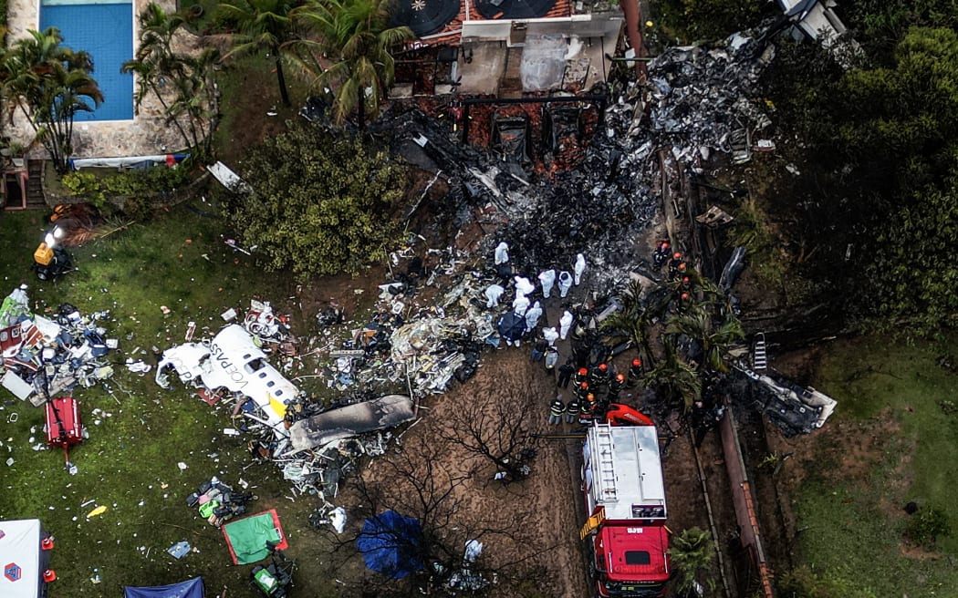 This photo shows an aerial view of the wreckage of an airplane that crashed with 61 people on board in Vinhedo, Sao Paulo State, Brazil, on August 10, 2024. An airplane carrying 57 passengers and four crew crashed on August 9 in Brazil's Sao Paulo state, killing everyone on board, the airline said. The aircraft, an ATR 72-500 operated by Voepass airline, was traveling from Cascavel in southern Parana state to Sao Paulo's Guarulhos international airport when it crashed in the city of Vinhedo. (Photo by Nelson ALMEIDA / AFP)