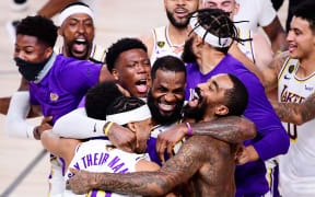 LeBron James #23 of the Los Angeles Lakers celebrates with Quinn Cook #28 of the Los Angeles Lakers and teammates after winning the 2020 NBA Championship in Game Six of the 2020 NBA Finals at AdventHealth Arena at the ESPN Wide World Of Sports Complex in Lake Buena Vista, Florida.