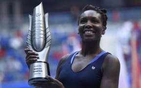 Venus Williams of the US poses with her trophy after beating Garbine Muguruza of Spain during the women's singles final at the Wuhan Open tennis tournament in Wuhan, central China's Hubei province on October 3, 2015. AFP PHOTO / FRED DUFOUR
