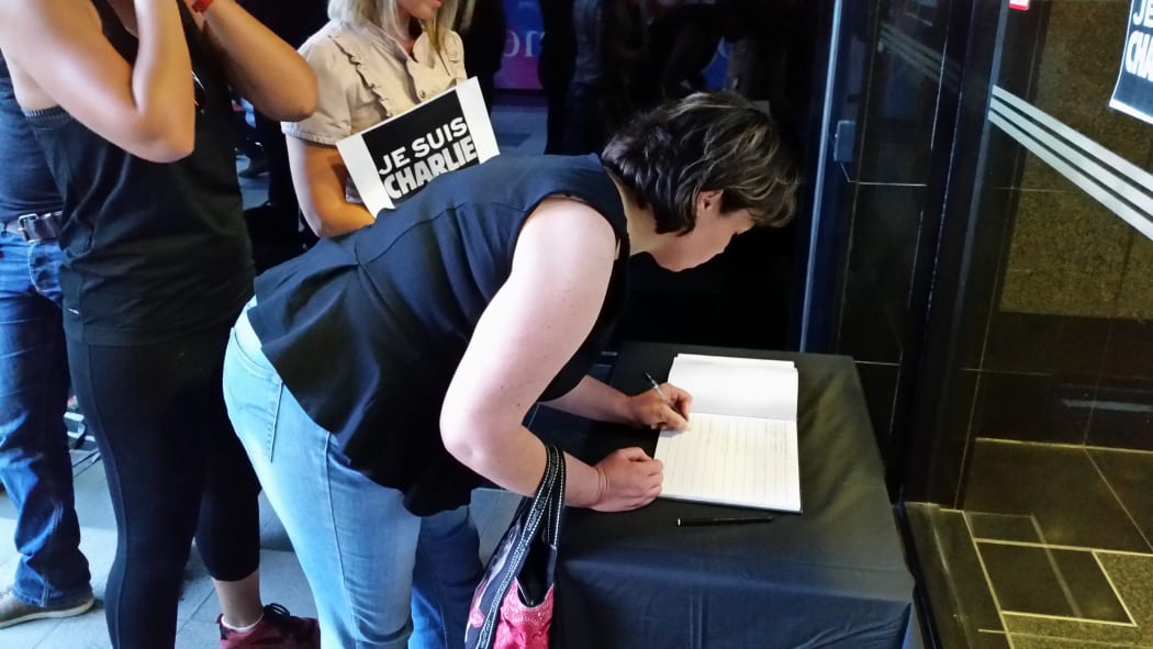Well-wishers sign the condolence book in Wellington