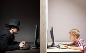 a man and a boy in front of computers