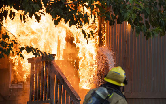 Firefighters battle an electrical fire in a mobile home park in Ridgecrest, California, on July 6, 2019 following a magnitude 7.1 earthquake on July 5. -