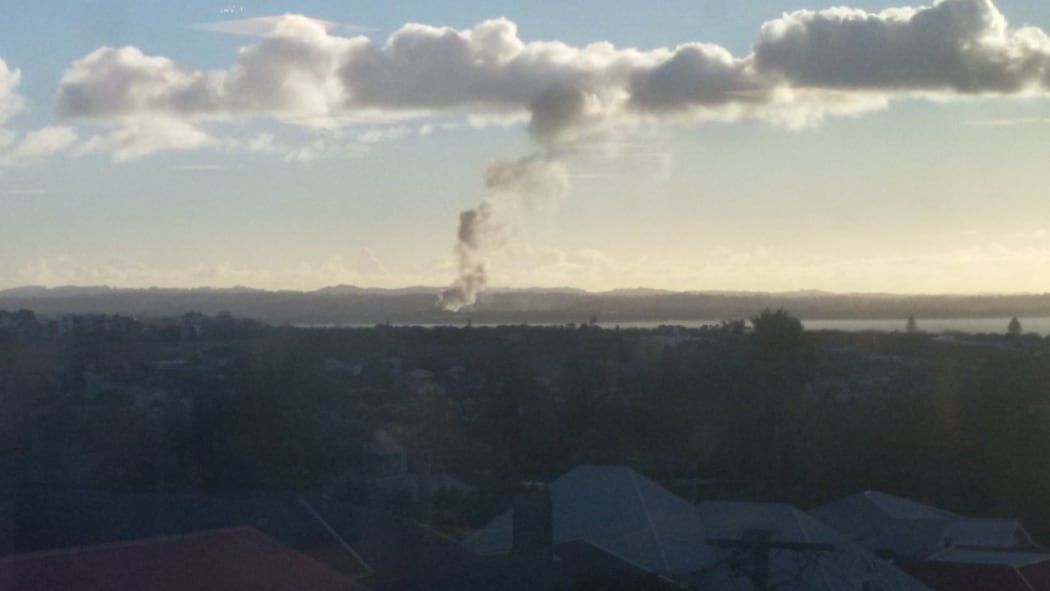 Smoke can be seen rising from the area of the Waitakere Refuse and Recycling Centre in Henderson.