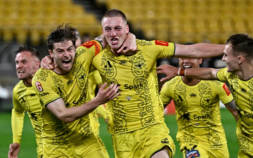Finn Surman and the Phoenix celebrate after scoring late against the Melbourne Victory FC at Sky Stadium in Wellington.