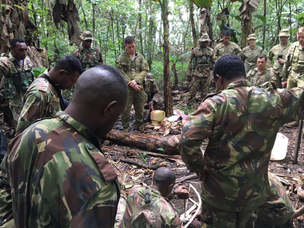 Australian soldiers are shown how to light a fire from scratch by their Papua New Guinea counterparts. August 2019