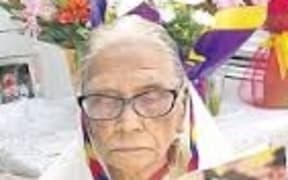 100-year-old Martha Vir reads her congratulatory letter from the Queen on her birthday at her home in Auckland on July 10.