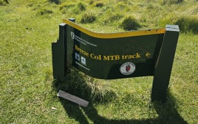 A bent sign at a Christchurch mountain bike track