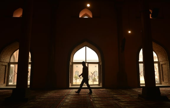 Kashmiri muslim walks by a window during the Friday prayer in Jamia Masjid in downtown Srinagar on November 25, 2016. 
TAUSEEF MUSTAFA / AFP