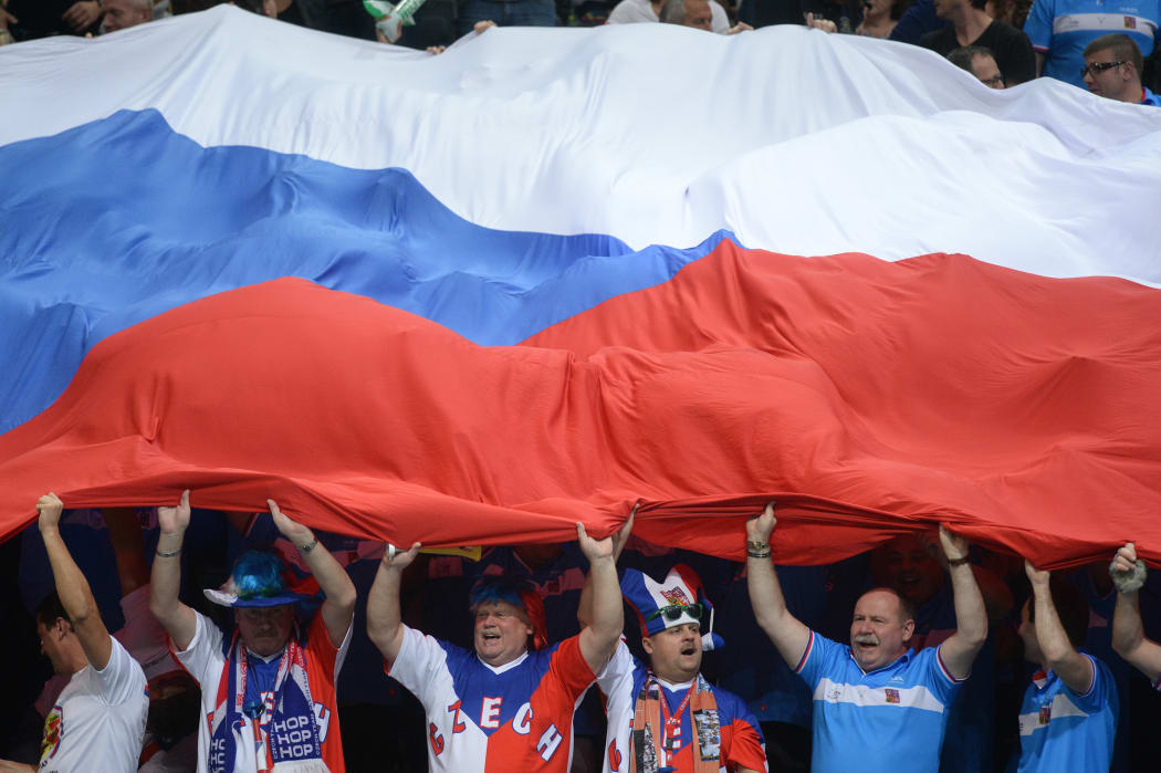 Czech Republic fans hold the country's flag at a tennis match.