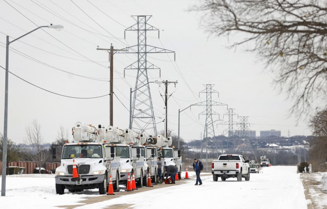 Electric service trucks line up after a snow storm in Fort Worth, Texas. Winter storm Uri has brought historic cold weather and power outages to Texas as storms have swept across 26 states with a mix of freezing temperatures and precipitation.