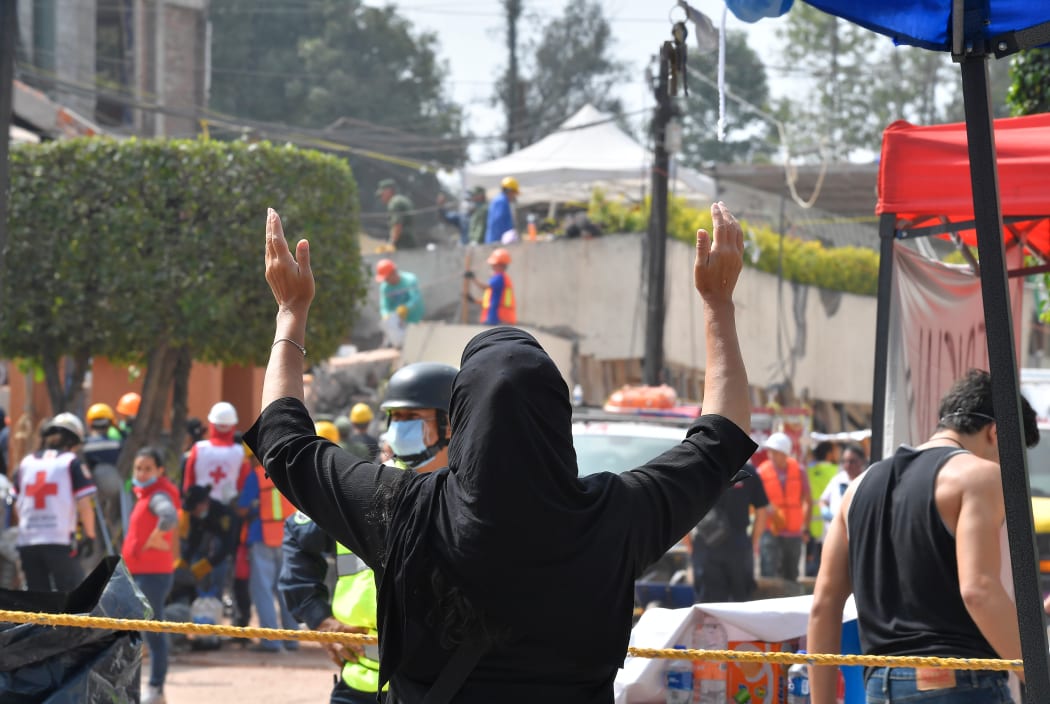A woman outside Enrique Rébsamen school in Mexico City where at least 21 children died.
