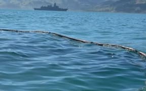 Oil spill from HMNZS Te Kaha is contained on Akaroa Harbour.
