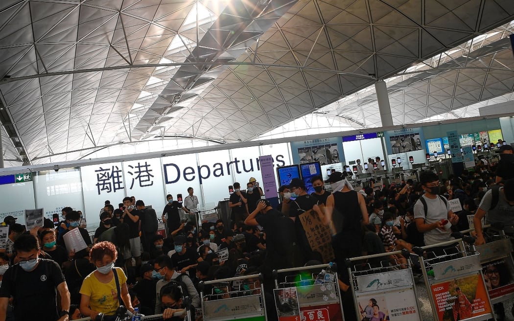 Hong Kong pro-democracy protesters block the departure gates