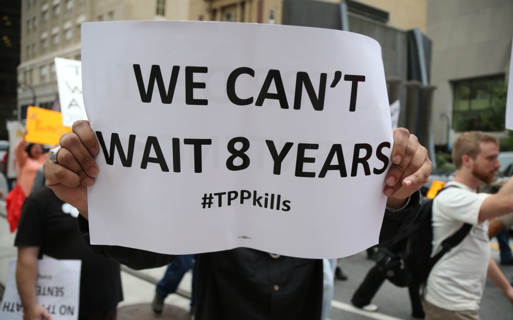 Protesters agasint TPP holding a banner "We can't wait 8 years", marching outside the hotel, where the second round of the talks is being held in Atlanta.