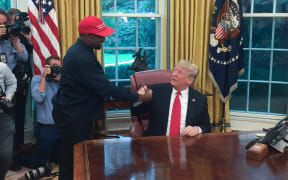 US President Donald Trump meets with rapper Kanye West in the Oval Office.