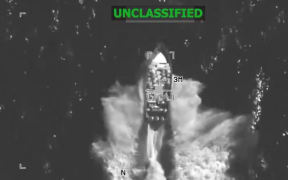 This screengrab from a video posted by the US Southern Command shows a strike on a vessel on December 4, 2025 at the direction of Secretary of War Pete Hegseth.