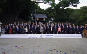 Japan's Finance Minister Taro Aso poses with delegation members during a photo of the G20 finance ministers and central bank governors meeting in Fukuoka.