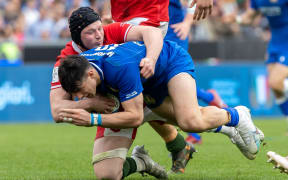Italy’s Tommaso Menoncello tackled by Jac Morgan of Wales.